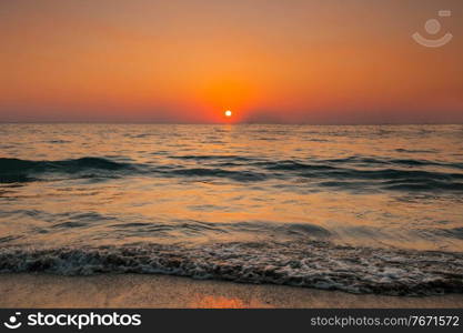 Beach and sea sunset, orange clear sky. Beach and sea sunset