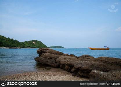 Beach and sea. The beaches of Koh Larn. Sand and sea with a ship moored in the calm sea.
