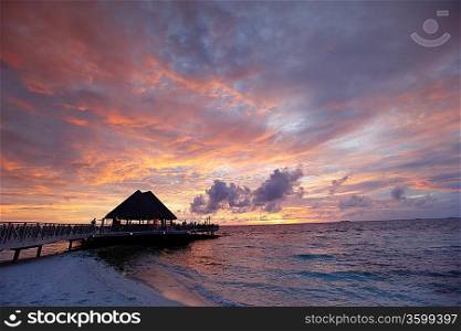 Beach and tropical houses on sunset
