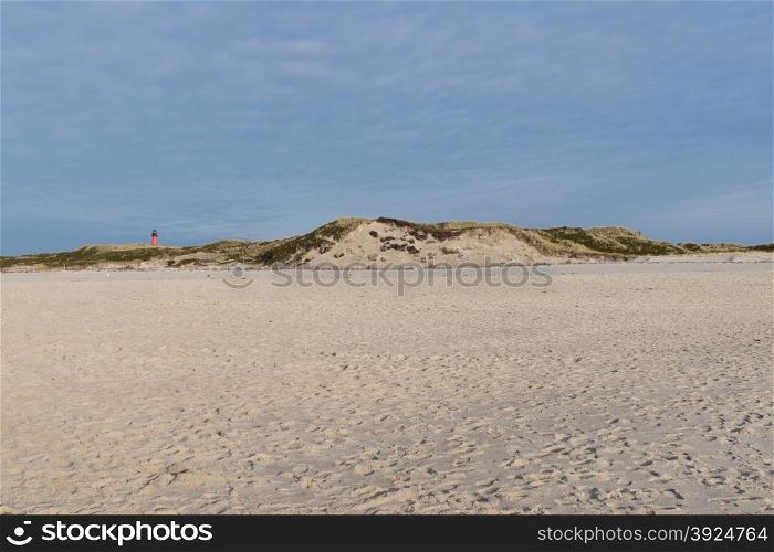 Beach at the south of the island of Sylt with view towards the light house of Hornum