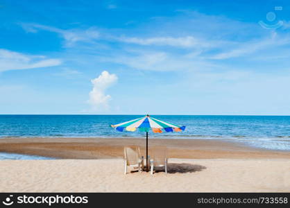 Beach beds and colourful umbrella with ocean horizon view and clear sky slightly clouds in summer - Tropical vacation holiday background wallpaper