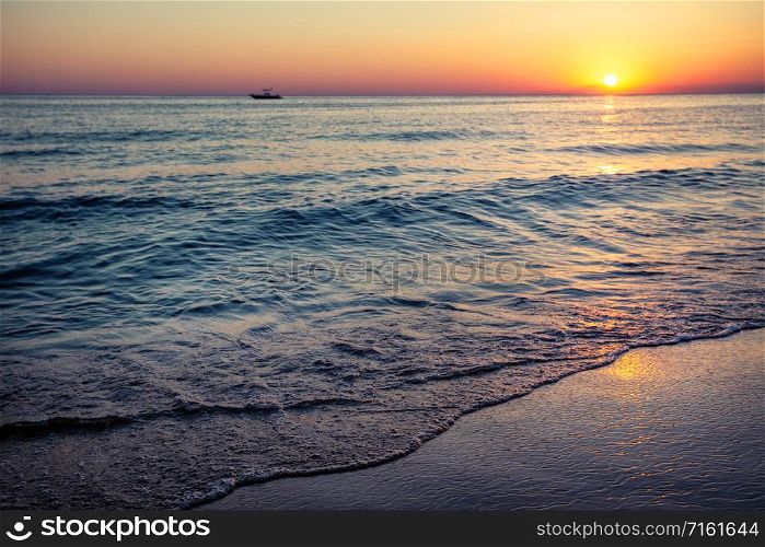 Beach by the sea at sunset. Summer landscape. Vacation and travel concept. Beach by the sea at sunset