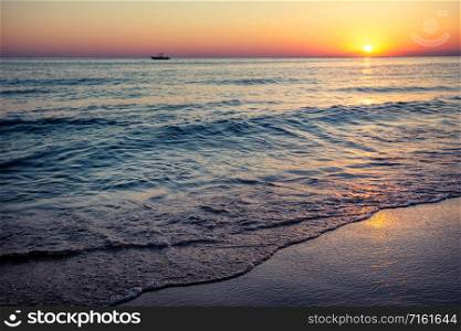 Beach by the sea at sunset. Summer landscape. Vacation and travel concept. Beach by the sea at sunset