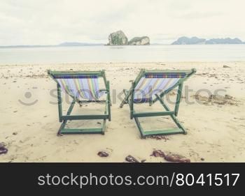 Beach chairs and beautiful beach (Vintage filter effect used)