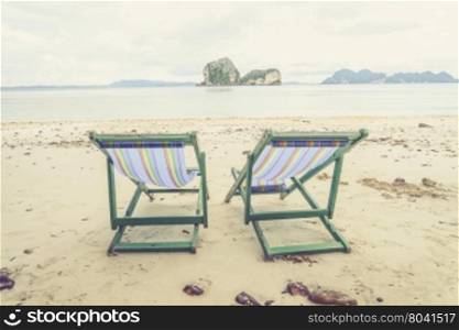 Beach chairs and beautiful beach (Vintage filter effect used)