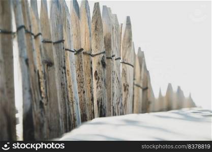 Beach details with a fence along the dune line on the dutch coast. Barrier  Ganivelle  at the edge of the beach to retain the sand and limit the passage of walkers