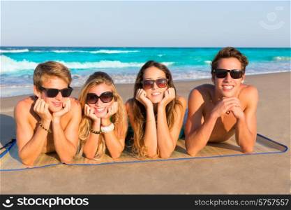 Beach friends together tourits portrait on the sand smiling happy