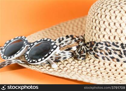 Beach hat and sunglasses with blue background