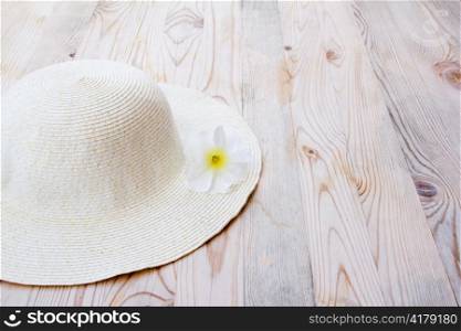 beach hat with white flower on clear woon