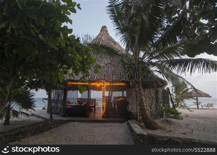 Beach hut at dusk, Utopia Village, Utila, Bay Islands, Honduras