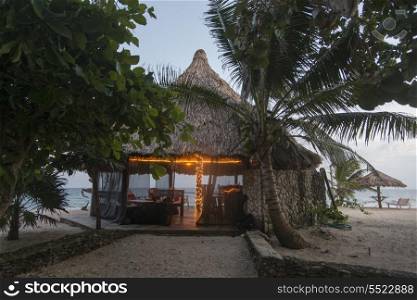 Beach hut at dusk, Utopia Village, Utila, Bay Islands, Honduras