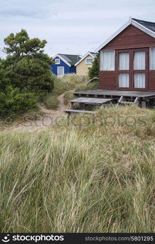 Beach huts on sand dunes and beach landscape