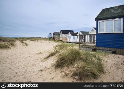 Beach huts on sand dunes and beach landscape