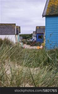 Beach huts on sand dunes and beach landscape