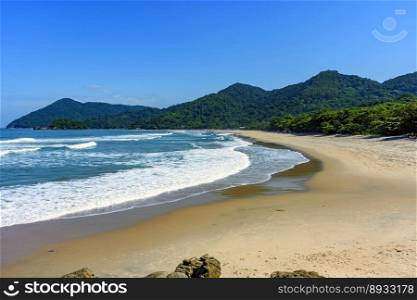 Beach in Bertioga on the north coast of the state of Sao Paulo surrounded by untouched forest and mountains . Beach in Bertioga on the north coast of the state of Sao Paulo