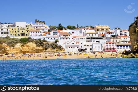 beach in Carvoeiro town with colorful houses on coast of Portugal