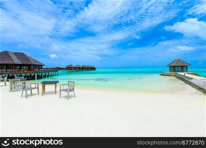 beach in Maldives with few palm trees and blue lagoon