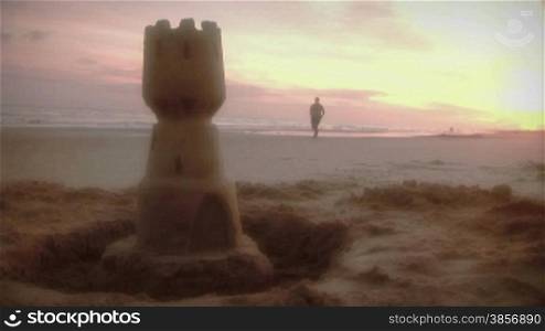 Beach Jogger and Sandcastle Sunrise or Sunset Surf HDV Video