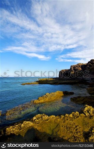 beach light water in lanzarote isle foam rock spain landscape stone sky cloud