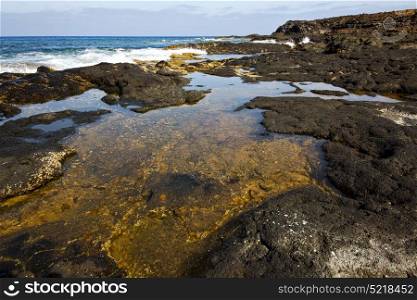 beach light water in lanzarote isle foam rock spain landscape stone sky cloud