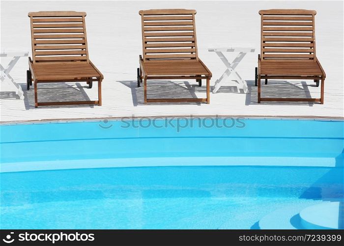 beach lounge chair near the pool on white boards
