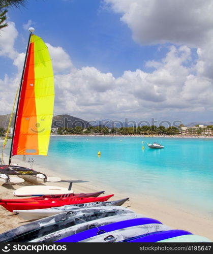 Beach of Puerto de Alcudia in Mallorca with hobie cat and kayak on Balearic Islands Spain