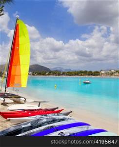 Beach of Puerto de Alcudia in Mallorca with hobie cat and kayak on Balearic Islands Spain