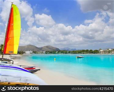Beach of Puerto de Alcudia in Mallorca with hobie cat and kayak on Balearic Islands Spain