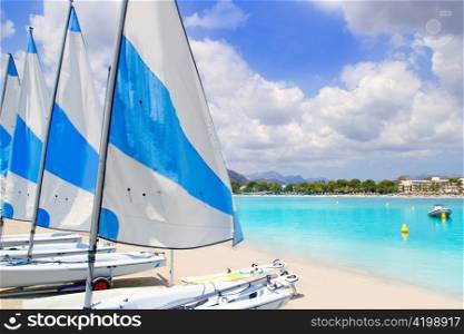 Beach of Puerto de Alcudia in Mallorca with little sailboats and white sand in Majorca