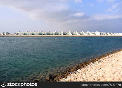 Beach on the sea coast and white apartments