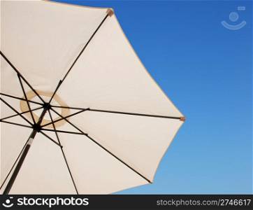beach or pool outdoor umbrella against a gorgeous blue sky background