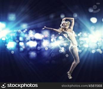 Beach party. Attractive girl in swim wear dancing in party lights