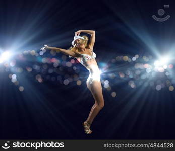 Beach party. Attractive girl in swim wear dancing in party lights