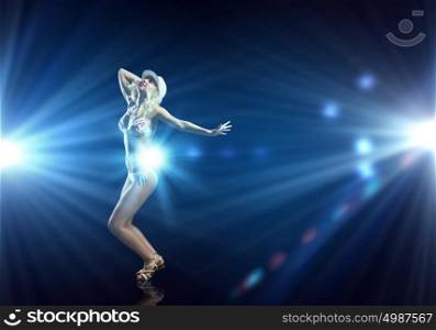 Beach party. Attractive girl in swim wear dancing in party lights