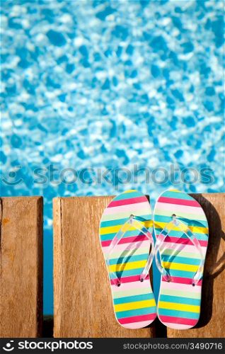 Beach`s flip flops on wood. Concept image of summer holidays