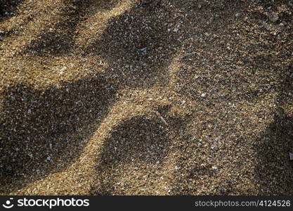 Beach sand texture background with shadows and highlights
