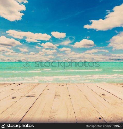 beach sea and blue sky clouds with wood table, vintage tone.