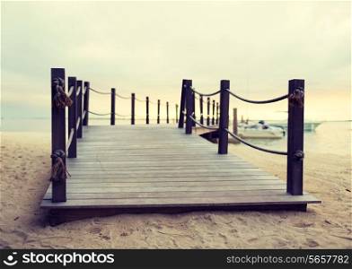 beach, sea, summer and leisure concept - close up of pier on tropical beach