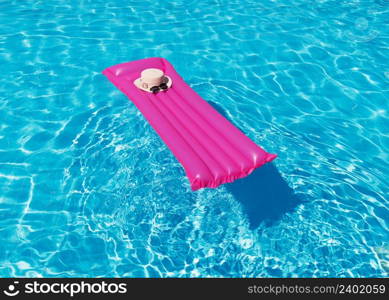 Beach summer holiday background. Inflatable air mattress and hat on swimming pool.;