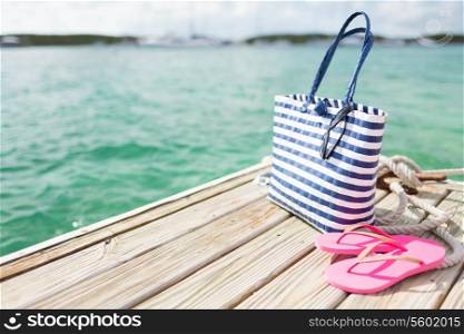 beach, summer, vacations and accessories concept - close up of beach accessories at seaside