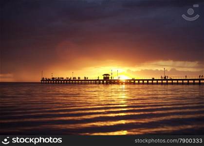 Beach Sunset or Sunrise and a Wooden Pier. Beach Sunset or sunrise with a wooden peir