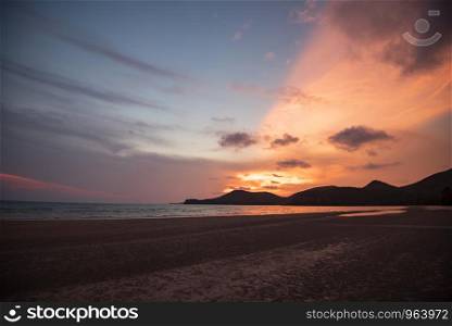 beach sunset silhouette islands beautiful beach sand on the tropical sea summer colorful orange and blue sky mountain background