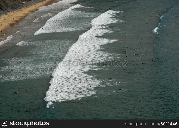 Beach, surfers from above, in the south of portugal