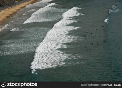 Beach, surfers from above, in the south of portugal
