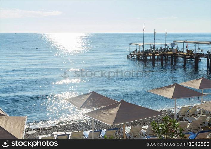 Beach umbrellas with sunbeds in Kemer. Beach umbrellas on the Mediterranean Sea in Kemer, Turkey