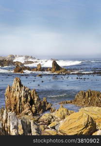 Beach Waves and Rocks. Rocks Formation on the Beach With Waves Crashing on the Rocks