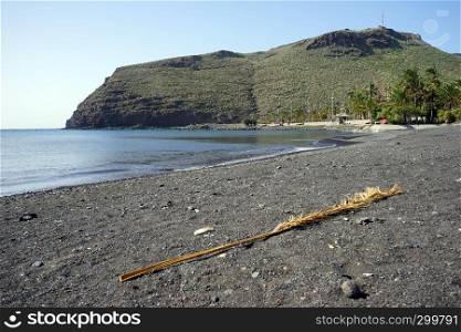 Beach with black sand in San Sebastian town in La Gomera island, Spain