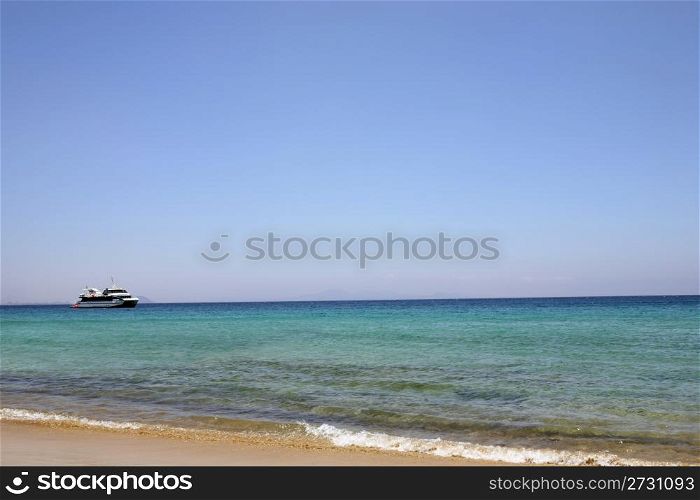 beach with nice blue water and pleasure craft have much space for text advertisement