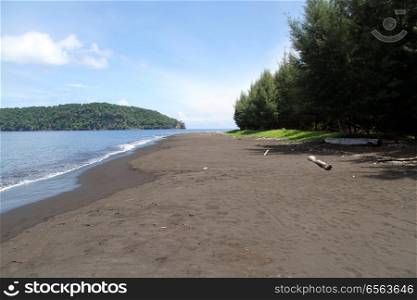 Beach with volcanic sand near volcano Krakatau in Indonesia
