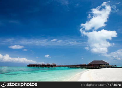 beach with water bungalows at Maldives